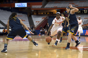 Alexis Peterson attacks the lane against Canisius on Tuesday night. Her 18 points and six assists helped Syracuse to a 70-37 win.
