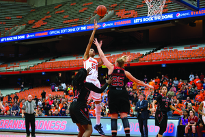 Briana Day lofts a floater over N.C. State's Carlee Schuhmacher. The SU center dominated, finishing with 11 points, 16 rebounds and seven blocks.