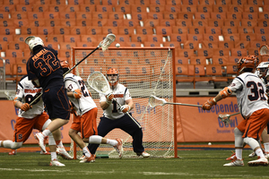 Bobby Wardwell braces for a shot on Sunday against Virginia. The senior goalkeeper posted 11 saves in the Orange's 15-9 win over the No. 5 Cavaliers.