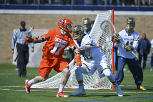 Syracuse attack Dylan Donahue, who scored seven goals in the Orange's loss, takes on a UND defender.