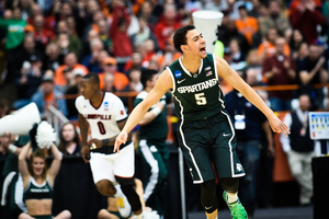 Michigan State's Bryn Forbes motions to the crowd during the Spartans' overtime victory over Louisville to advance to the Final Four.