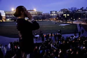 Paul Ang, a graduate student at SU, speaks in front of a crowd outside of Hendricks Chapel Tuesday during Take Back the Night. The event had a record number of organizations participate this year.