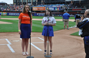 (from left) Libby Weber and Megan Murphy perform the National Anthem in front of over 30,000 fans. 