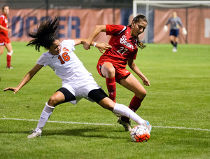 Syracuse forward Alex Lamontagne is clipped by the Red Storm's Allie Moar as she goes for the ball. Physicality was the theme in SU's 1-0 loss Friday night at home.