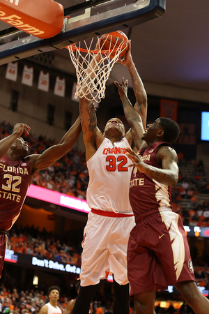 Dajuan Coleman places his dunk just out of reach from two Florida State defenders. His six consecutive points bolstered a three-point Syracuse lead. 