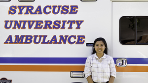 Senior Lily Kim stands outside a Syracuse University Ambulance, where she has worked all through college