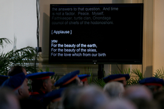 Lyrics for a Christian hymn, sung by University Singers, appear on a TV screen for audience members to read on April 11, 2014. 