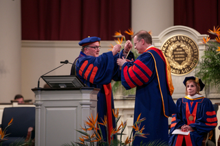 Board of Trustees Chairman Dick Thompson hands Chancellor Kent Syverud the chancellor medallion on April 11, 2014.