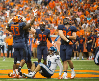 The Syracuse defense rejoices after tackling Robertson in the backfield.
