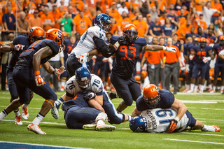 Syracuse defensive end Rob Welsh brings Robertson to the ground to thwart Villanova's attempt at a two-point conversion and seal the Orange's win.