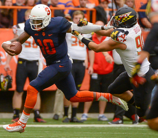 Terrel Hunt stiff-arms Roman Braglio during Syracuse' 34-20 loss to Maryland. Hunt ran for 156 yards and two touchdowns on 23 attempts Saturday.