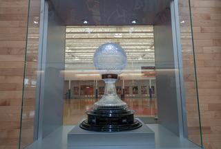 Syracuse won the national championship trophy in 2003 and it is showcased in the middle of the facility's hallway. When the lights turn off, the players still practicing can see it glow. 