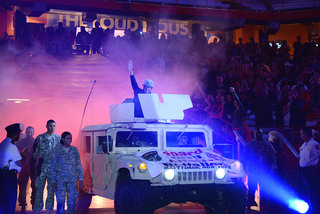 Syracuse men's basketball head coach Jim Boeheim comes out in a military vehicle with a helmet on to pay respect to all United States troops. 