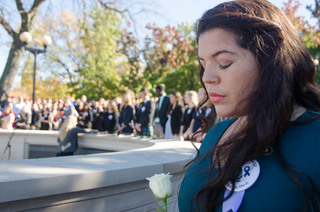Alexandra-Marie Miranda, a dual anthropology and international relations major and Remembrance Scholar, waits to lay her rose in commemoration of the Lockerbie victims.