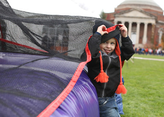 Blake Barlow of Liverpool, NY plays with the inflatable jump house on the quad prior to the start of the Duke vs. Syracuse football game.