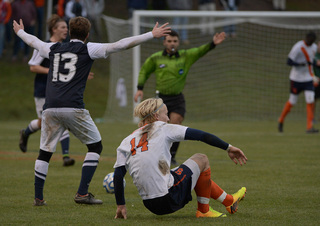 Ekblom picks himself up off the ground as Penn State's Mike Robinson throws his hands up and looks at an official.