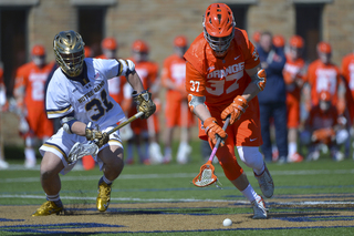 SU faceoff specialist Ben Williams goes to pick up a ground ball.