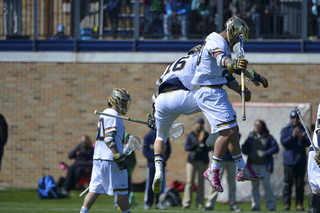 Perkovic leaps high in the air with his teammate after a goal for the Fighting Irish.