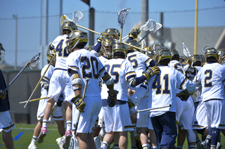 Notre Dame piles onto Jack Near – who scored the unassisted, game-winning goal in double-overtime – giving the Fighting Irish a shot to overtake Syracuse as the top-ranked team in the country.