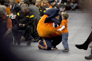 Otto high fives Willem Groat at the basketball game. Groat, 2, said he loves playing with Otto the Orange. 