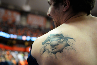 Kyle Fenton shows off his tattoo of Otto the Orange. He wanted a way to commemorate his memories as the beloved SU mascot. 