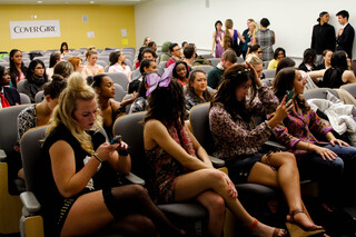 Audience members wait for the eighth annual Fashion and Beauty Communications Milestone fashion show to start.