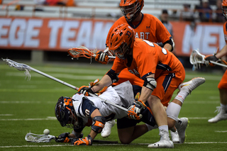 A Syracuse player gets laid out on the ground. The Orange still picked up 12 more ground balls than the Statesmen. 