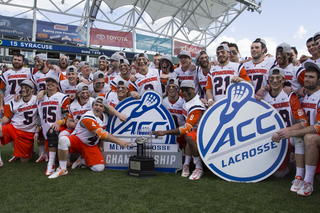 Syracuse players pose with the ACC championship trophy after their 15-14 win over Duke at PPL Park in Chester, Pennsylvania.