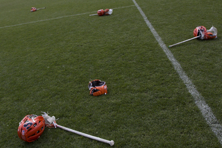 SU helmets, sticks and gloves lie on the PPL Park grass.