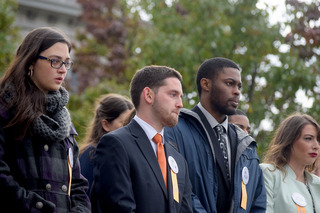 Syracuse University 2016-17 Remembrance Scholars Kelsey May, Terence Wells and Nigel Miller stand during the Rose Laying Ceremony.
