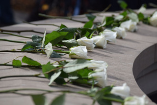 The white roses represent the SU students that lost their lives. 